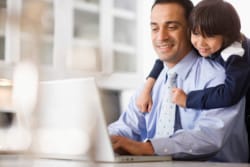 Boy Watching Father while Use Laptop
